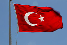 Turkish flag flies pround