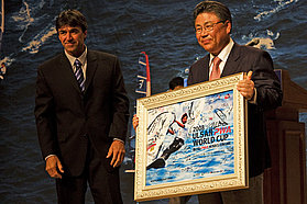 The mayor of Ulsan Metropolitan City Maeng Woo Park is presented with a signed PWA poster